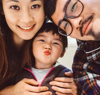 Happy family of three taking a selfie together